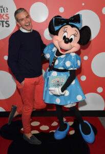 WEST HOLLYWOOD, CA - JANUARY 17:  Fine art photographer Gray Malin poses with global style icon Minnie Mouse at the Andaz Hotel in West Hollywood. Minnie debuted a custom Olympia Le-Tan dress and Malin created a photo series with Minnie Mouse as his muse.  (Photo by Lester Cohen/Getty Images for Disney Consumer Products and Interactive Media)